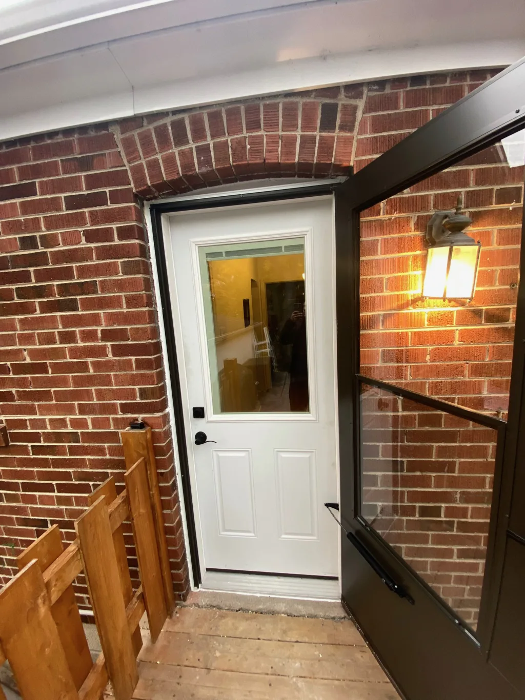 Freshly secured residential entry door behind an open storm door